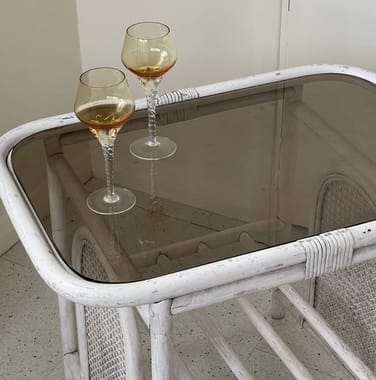 two glasses of wine sitting on a table