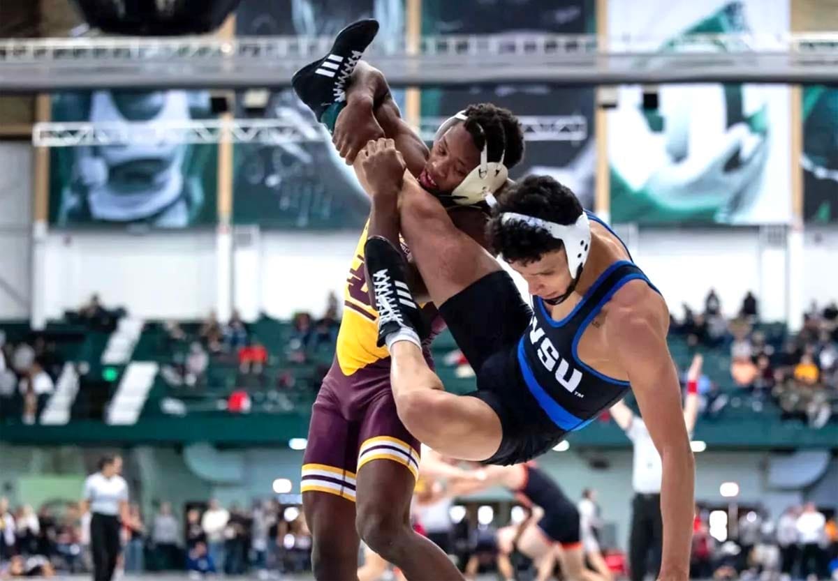 A wrestler takes down his opponent. 