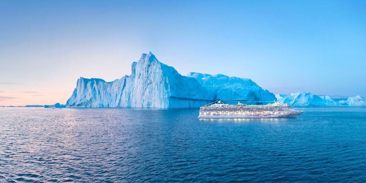 Norwegian Cruise Line by an iceberg