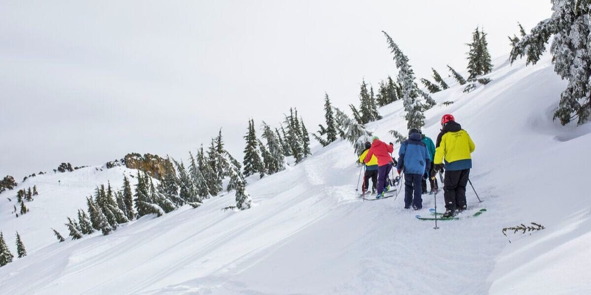 a bunch of skiers waiting their turn to go skiing