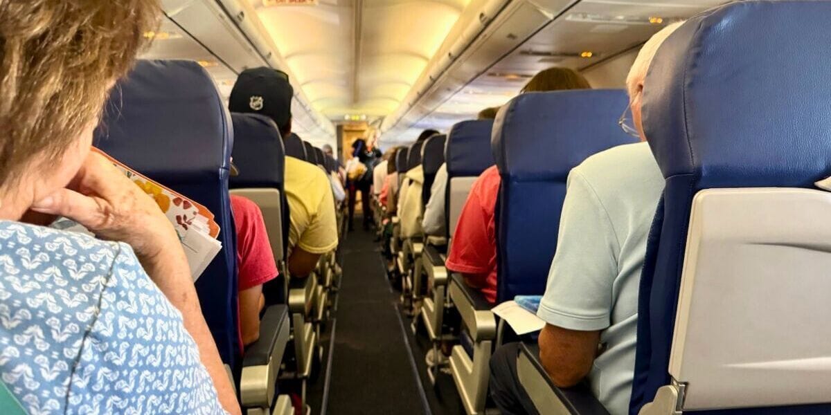 airplane aisle with people seated