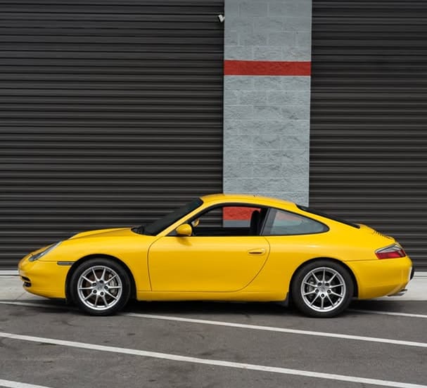 Speed Yellow 2001 Porsche 996 Carrera 4 with manual transmission, 77K miles, sold by a certified Porsche technician in Orlando, FL. Listed for $33,000.