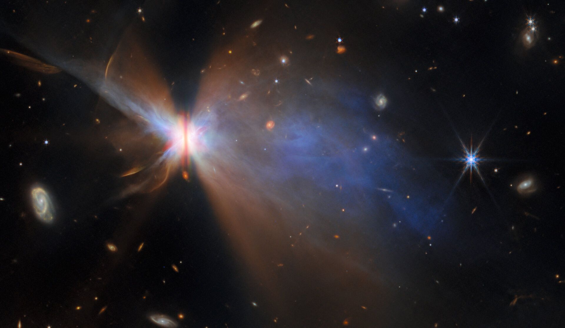 Edge-on view of the planet-forming disc IRAS 04302, captured by the James Webb Space Telescope in the Taurus star-forming region, about 525 light-years from Earth. The dark vertical band is a dense protoplanetary disc surrounding a young protostar, blocking its light and revealing delicate reflection nebulas on either side. These dusty wisps, illuminated by scattered starlight, trace the vertical structure of the disc where dust grains settle and grow—key steps in planet formation. Webb’s infrared instruments highlight the fine distribution of dust, while complementary Hubble data reveal clumps and outflows, suggesting the star is still actively gathering mass.