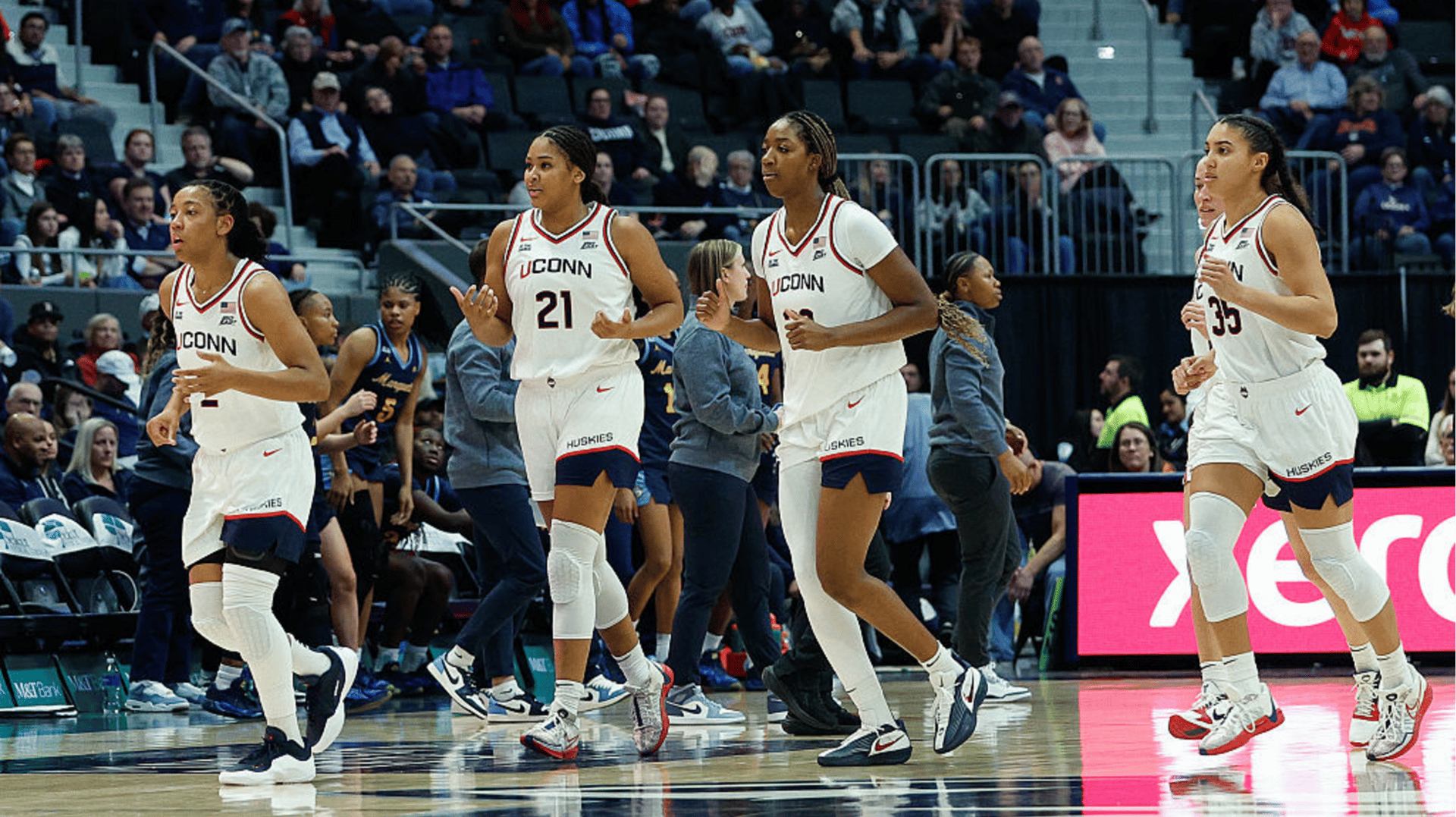 Kk Arnold #2 of the UConn Huskies, Sarah Strong #21 of the UConn Huskies, Serah Williams #22 of the UConn Huskies, and Azzi Fudd #35 of the UConn Huskies jogs to the bench after a timeout during the women's college basketball game between Marquette Golden Eagles and UConn Huskies on December 17, 2025, at PeoplesBank Arena in Hartford, CT.