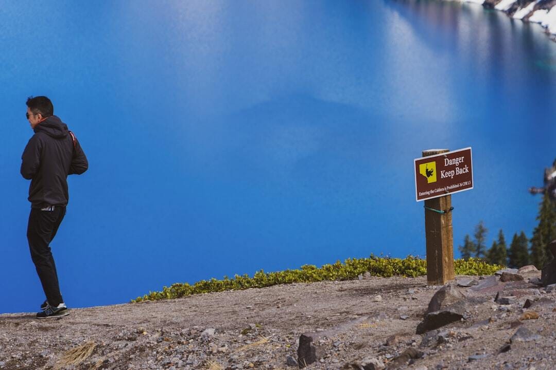 In this picture there’s a sign and a person making a really poor decision. This guy ignored the signs at Crater Lake in Oregon and then nearly fell as he tried to get closer to the edge to take photos. That shortly after a couple nearly fell trying to take a selfie. I’m amazed more people don’t fall to their deaths at crater lake... the guy in this picture was caught and then chewed out royally by a park ranger. 