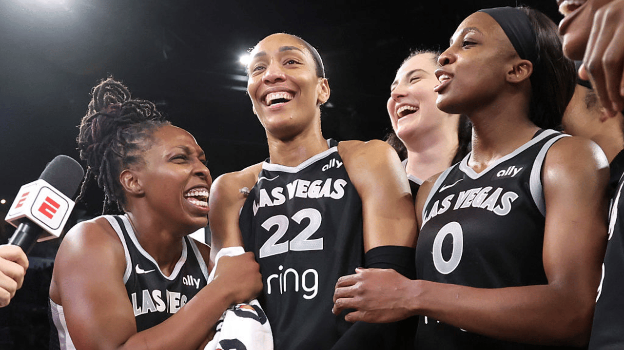 Chelsea Gray #12, A'ja Wilson #22, Megan Gustafson #17 and Jackie Young #0 of the Las Vegas Aces react as they are interviewed after the team's 107-98 overtime victory over the Indiana Fever in Game Five of the 2025 WNBA Playoffs semifinals at Michelob ULTRA Arena Michelob ULTRA Arena on September 30, 2025 in Las Vegas, Nevada. 