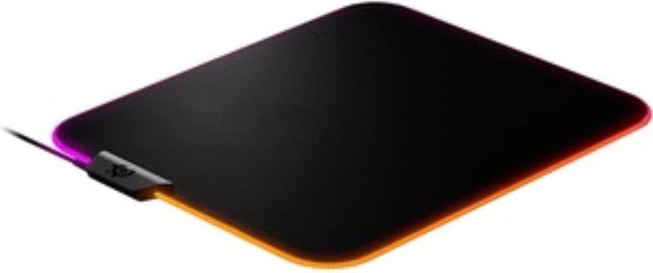 SteelSeries QcK Prism XL – The RGB Star A large, soft gaming mouse pad with vibrant RGB lighting around the edges, displayed under a Valorant esports setup.