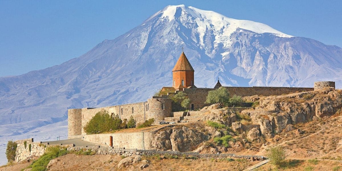 a castle before a mountain vista in Armenia
