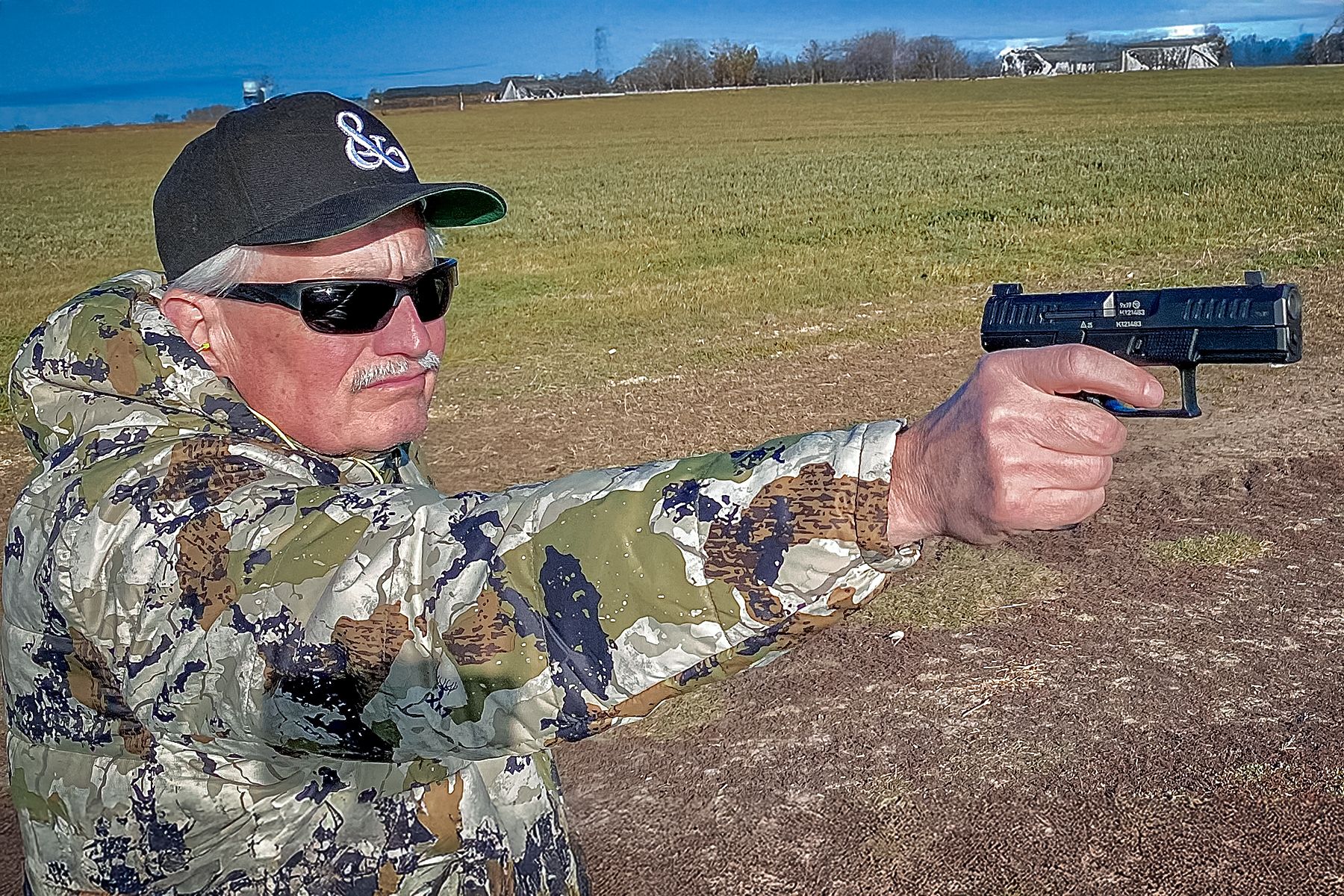 man firing a CZ P10 C