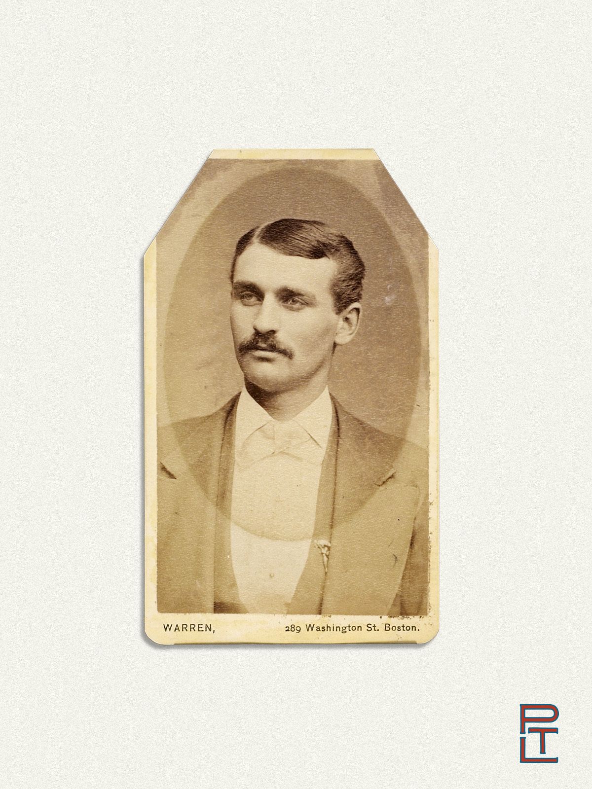 A sepia-toned 19th-century portrait photograph of a man with a neatly groomed mustache and parted dark hair, dressed in a formal suit with a bow tie. The photograph is mounted on a card with beveled top corners and the name “Warren” and the address “289 Washington St. Boston” printed at the bottom. The image is set against a pale gray background with a modern "PTL" logo in the lower right corner.