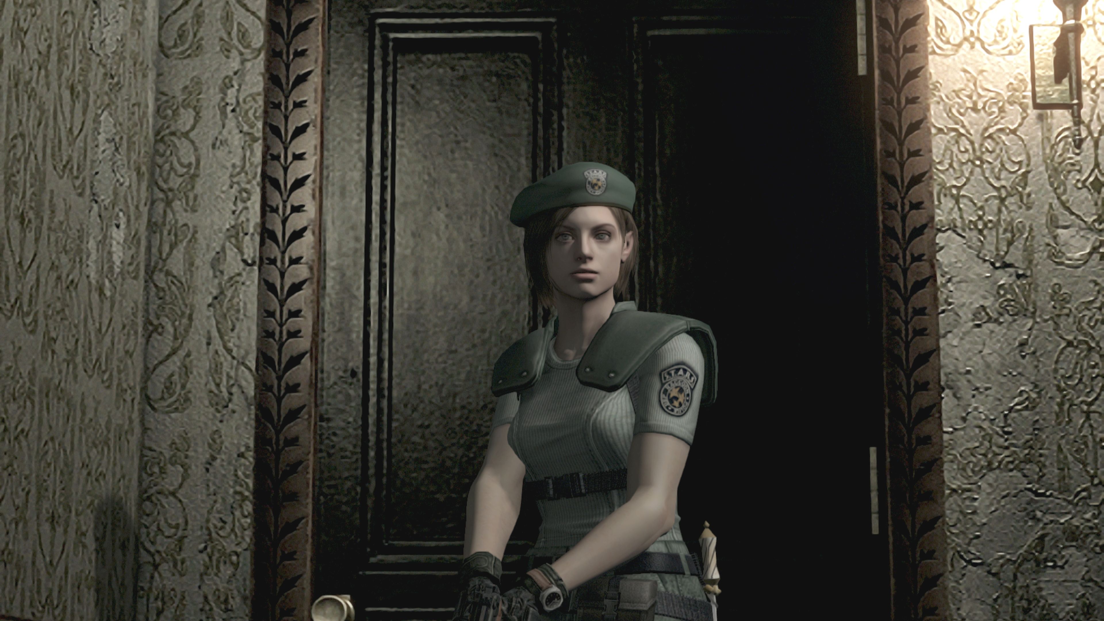A screenshot from the 2002 remake of Resident Evil, in its later HD form, showing Jill Valentine close up after walking through a door. You cannot see what she sees — she's not looking at you as you are looking at her, but instead, at the room in front of her that you have no view of.