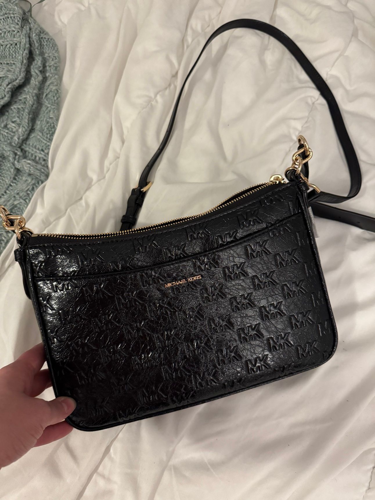 a black leather Michael kore purse