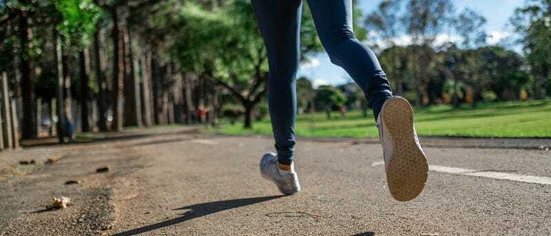 Person walking outside to recharge and reduce stress