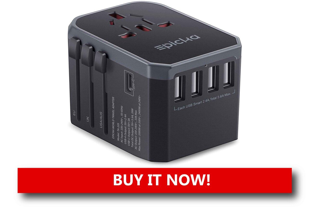A Universal Travel Adapter That Works Everywhere A compact travel adapter with multiple plug options and USB ports plugged into a wall outlet, charging a phone and tablet simultaneously.