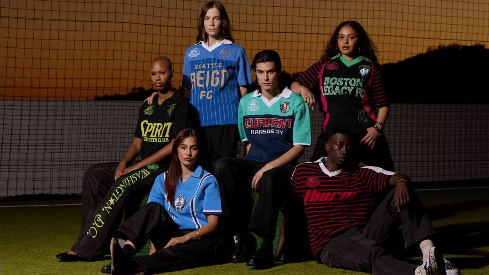 Six people model the NWSL x Dead Dirt knit jersey collection on a soccer ptich.