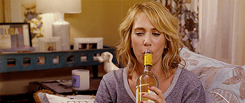Kristen Wiig drinking wine from the bottle.