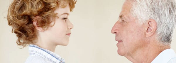 A boy and a man look at each other