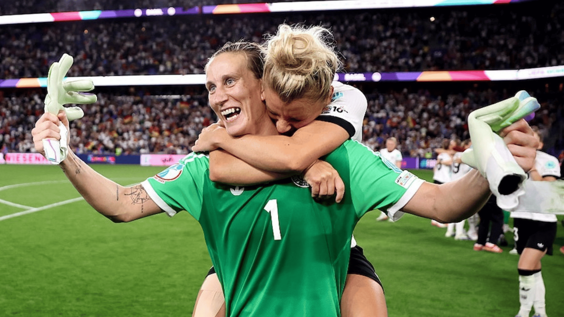 Ann-Katrin Berger of Germany celebrates victory with teammate Linda Dallmann after Germany defeat France 6-5