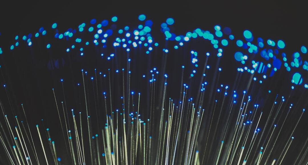 fiber optic light image with red hue on black background. Ideal image to depict broadband, technology, speed and cable infrastructure.