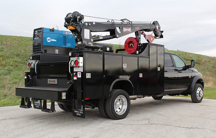 Black custom mechanic truck equipped with a service crane, welder, and compressor — a heavy-duty upfit configuration not typically found on dealership lots, ideal for fleets that require specialized equipment.
