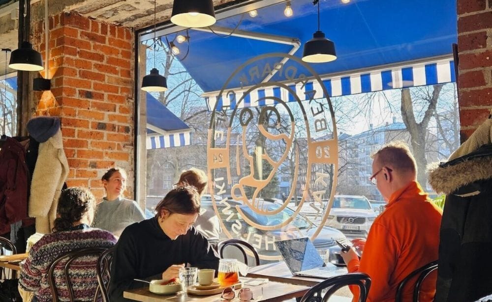 two people drinking coffee at a coffee shop