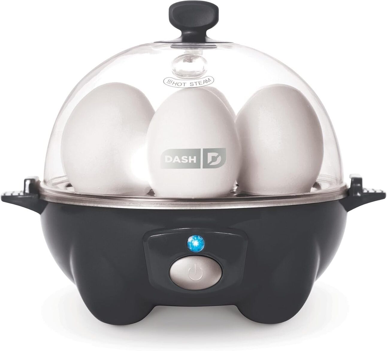 Dash Rapid Egg Cooker – A compact white egg cooker with a clear dome lid, shown steaming six eggs on a kitchen counter. Buttons and timing guide are visible, highlighting its simplicity and functionality.