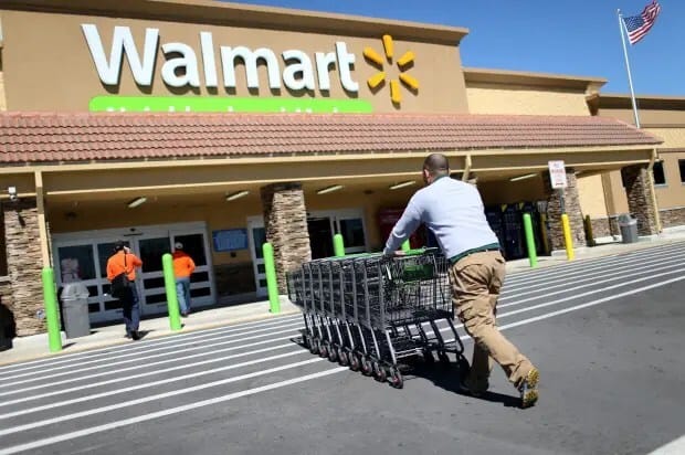 MIAMI, FL - FEBRUARY 19: Walmart employee Yurdin Velazquez pushes grocery carts at a Walmart store on February 19, 2015 in Miami, Florida. The Walmart company announced Thursday that it will raise the wages of its store employees to $10 per hour by next February, bringing pay hikes to an estimated 500,000 workers. (Photo by Joe Raedle/Getty Images)