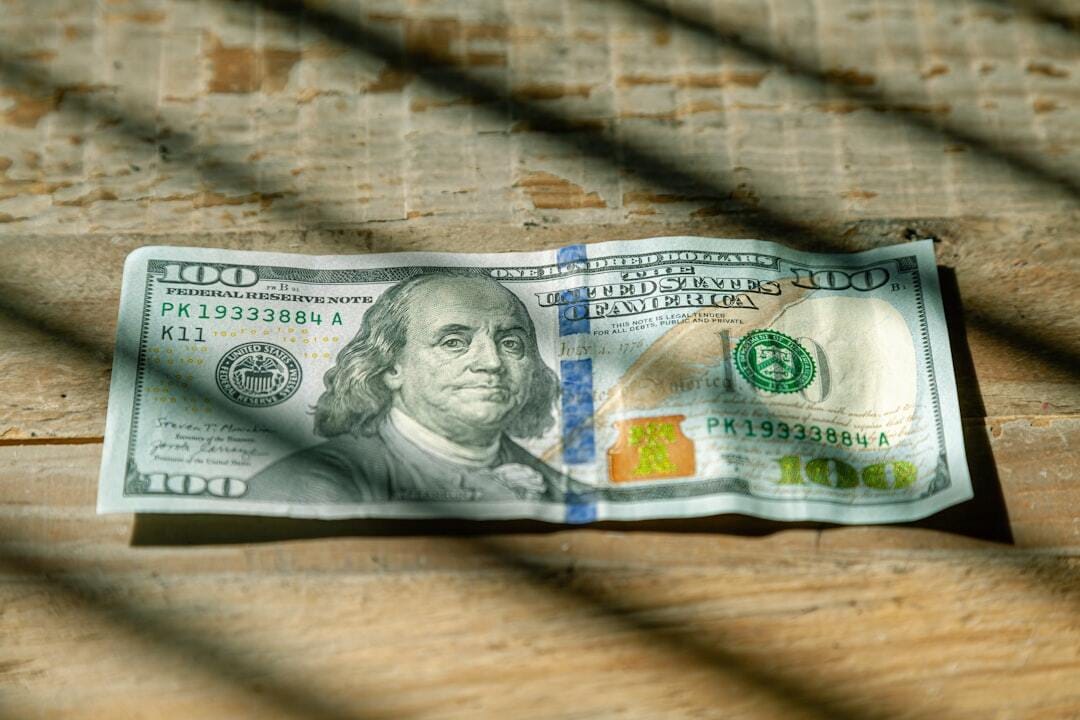 US Currency One hundred dollar bill flat lay on wood background