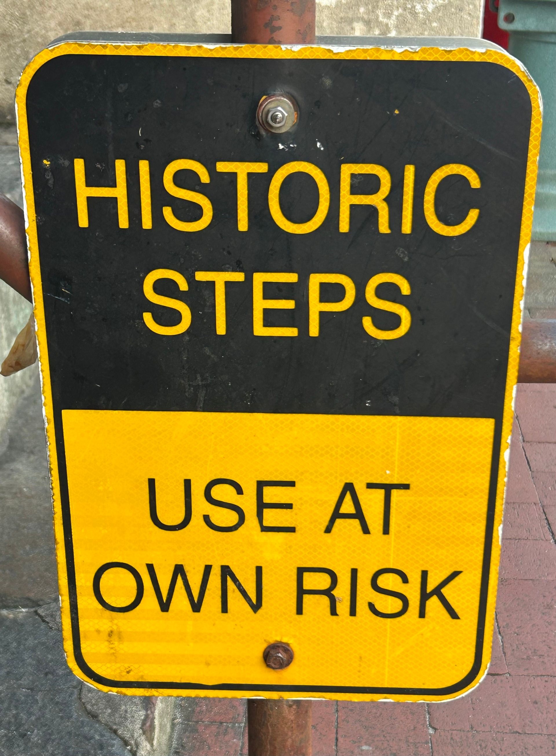 Image of a sign saying "Historic steps: Use at Your Own Risk"