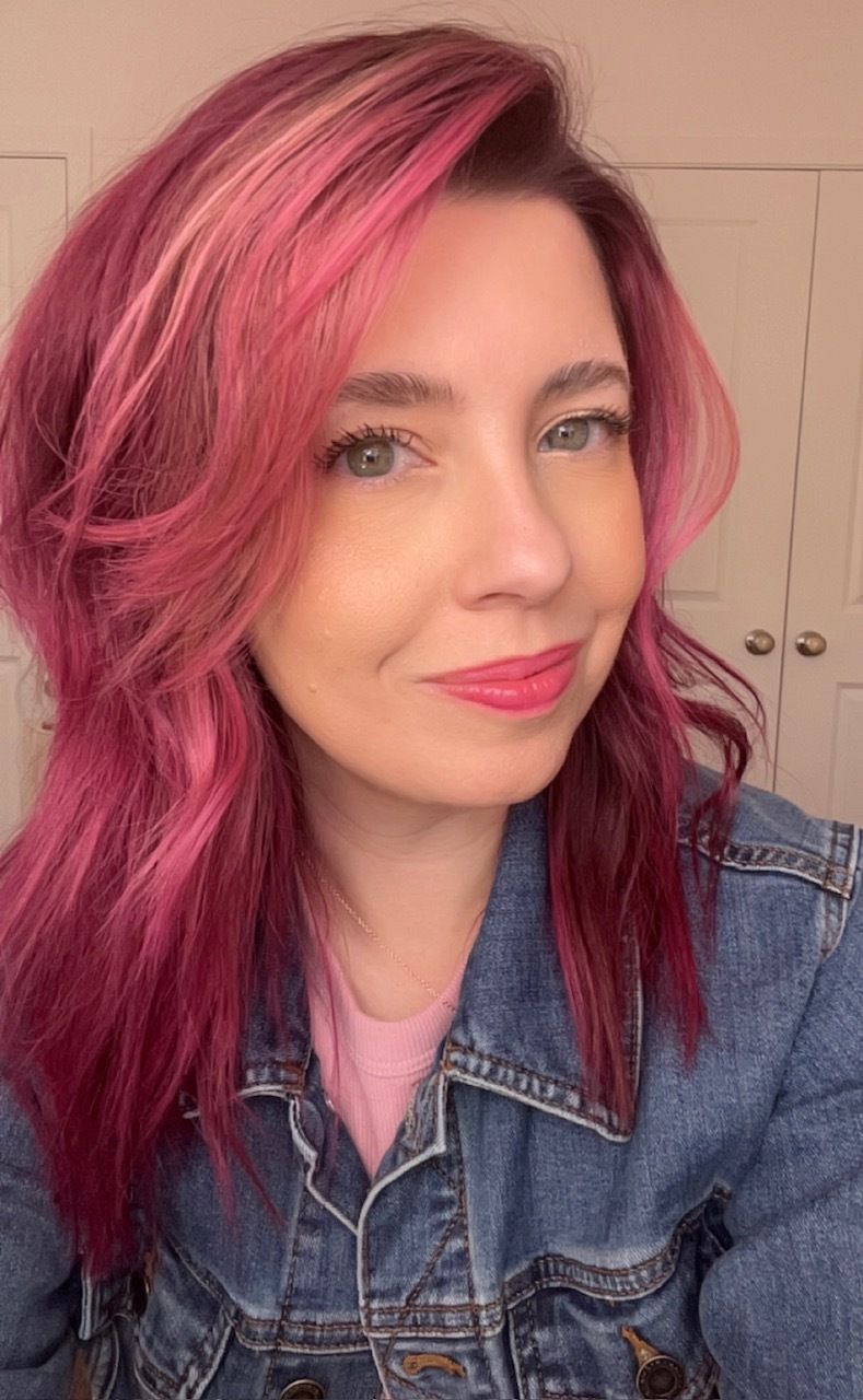 a photo of Natalie with magenta hair smiling