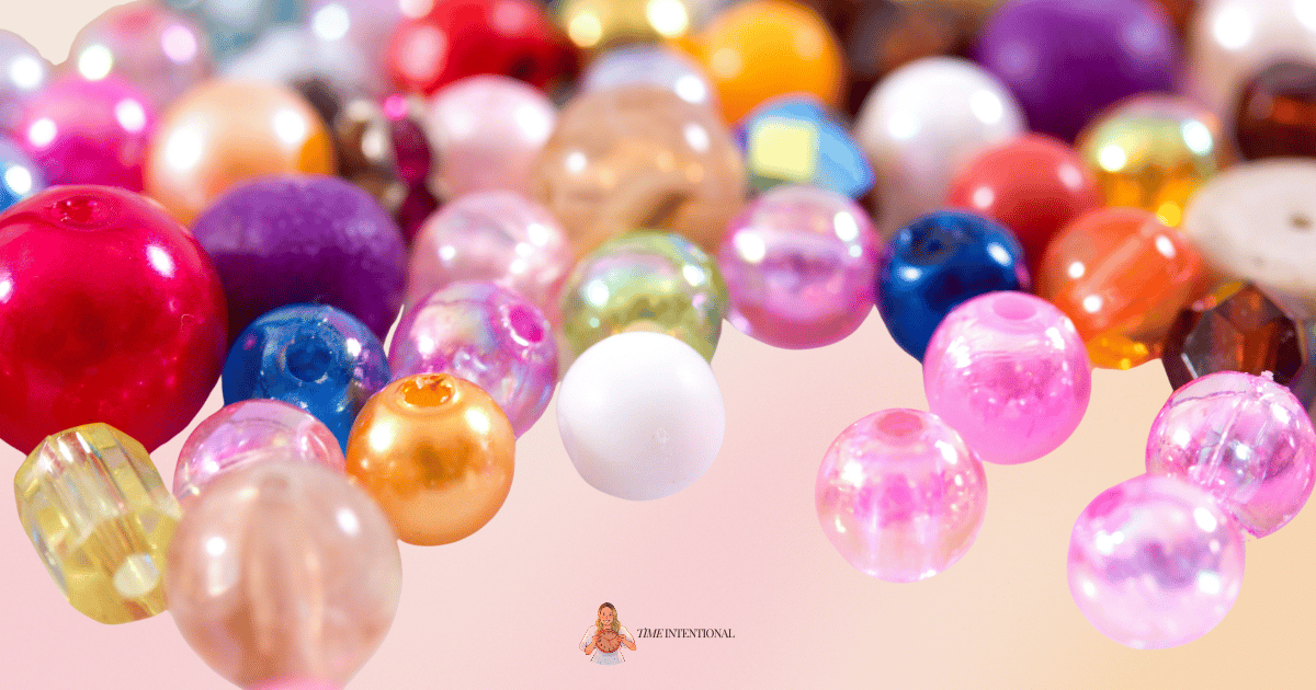A pile of bright, colorful beads in different shapes, colors, and sizes