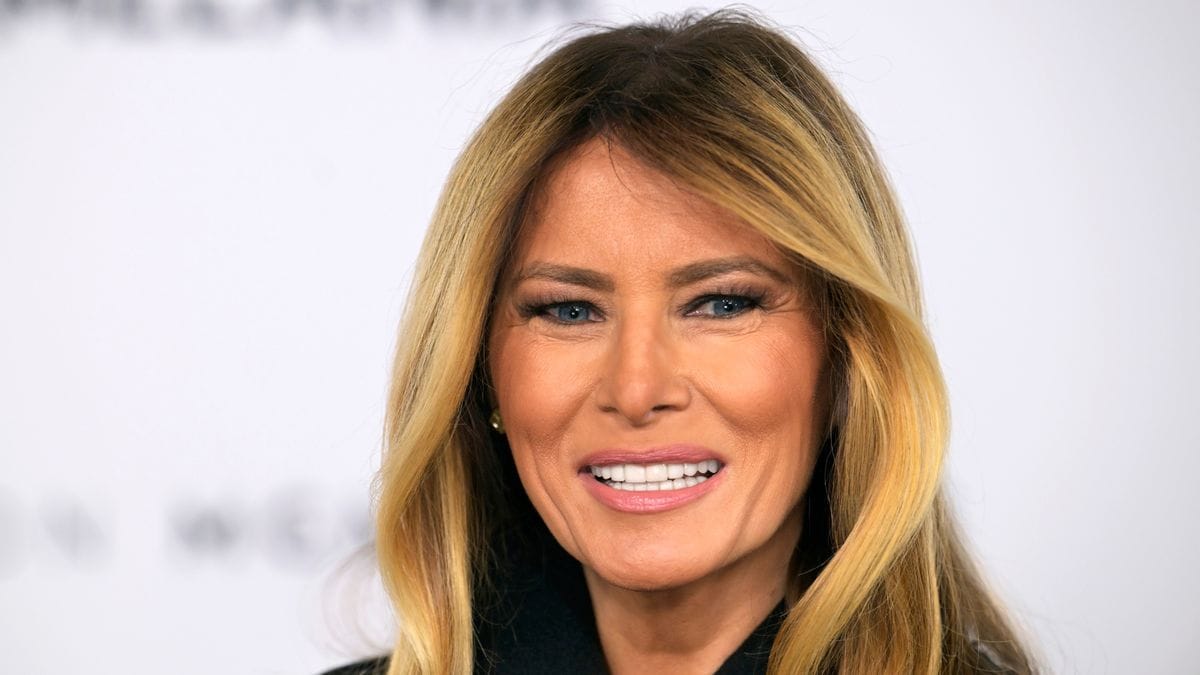 A white woman is pictured smiling.