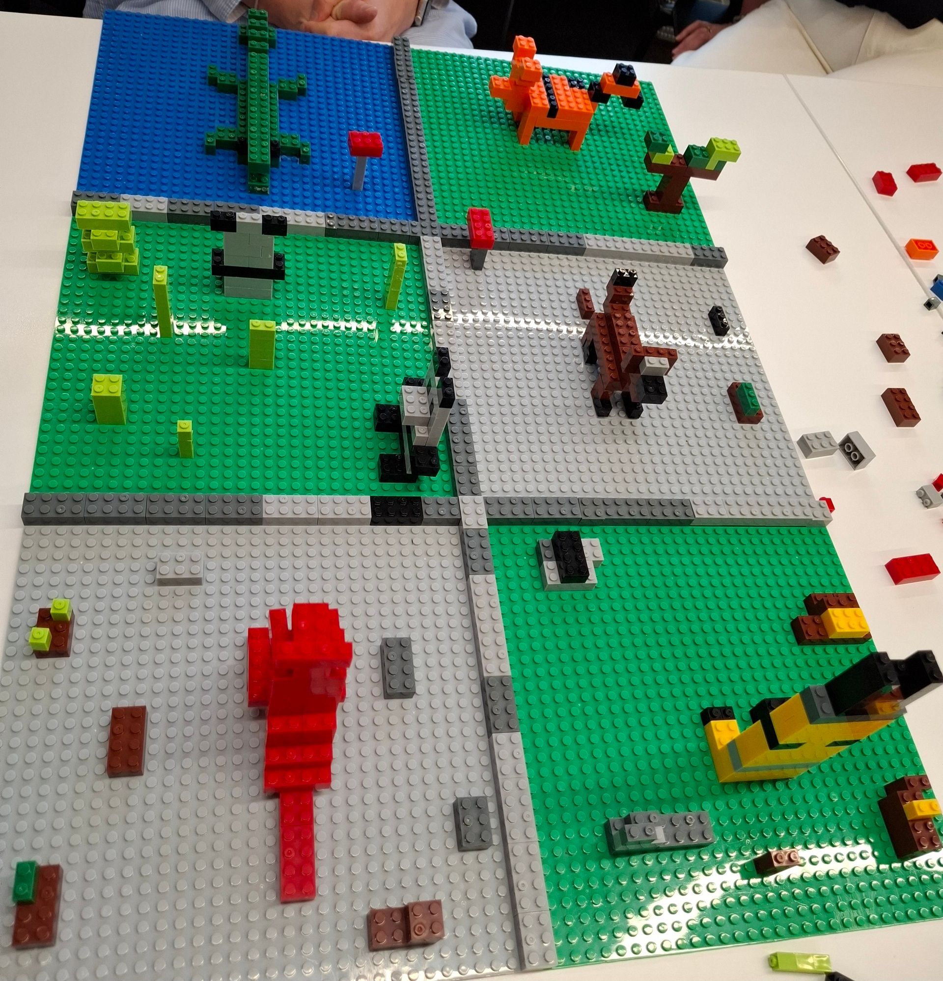 a basic zoo in lego with kangaroo, dog, panda, crocodile, meerkat and tiger