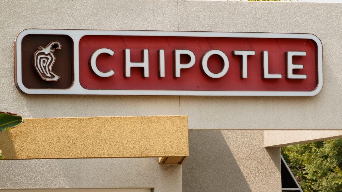 A store front says CHIPOTLE next to a stylized jalapeño pepper.