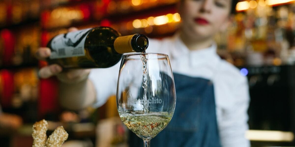 pouring a glass of white wine