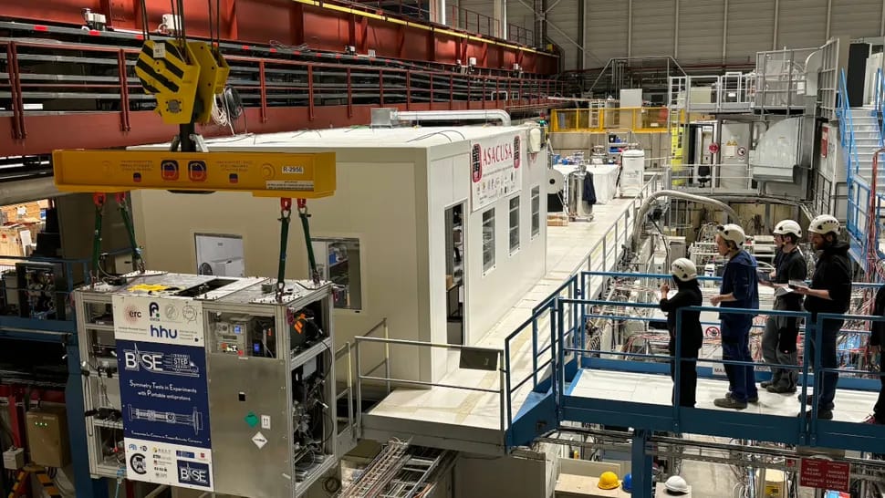The BASE-STEP portable Penning trap, being lowered by crane (bottom left) at CERN.