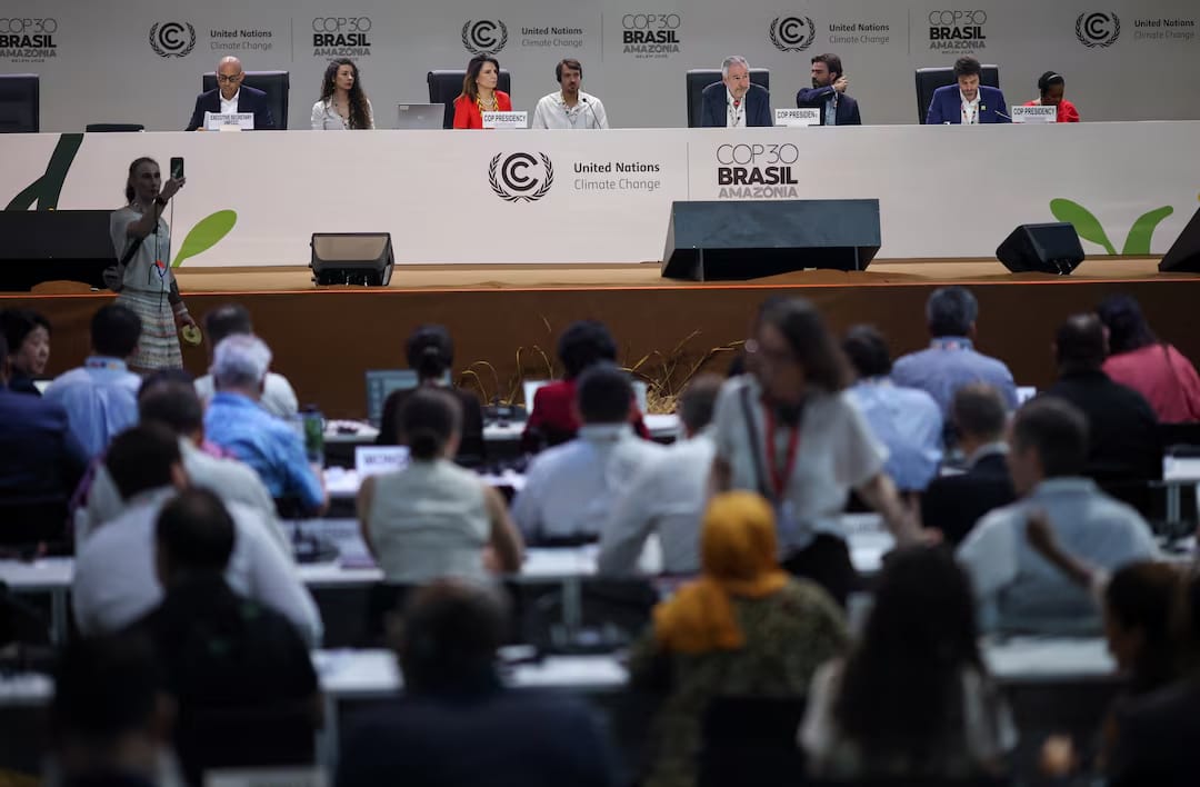 Plenary session at COP30 in Brazil showing delegates seated in the audience and COP30 presidency panelists on stage during United Nations climate negotiations.