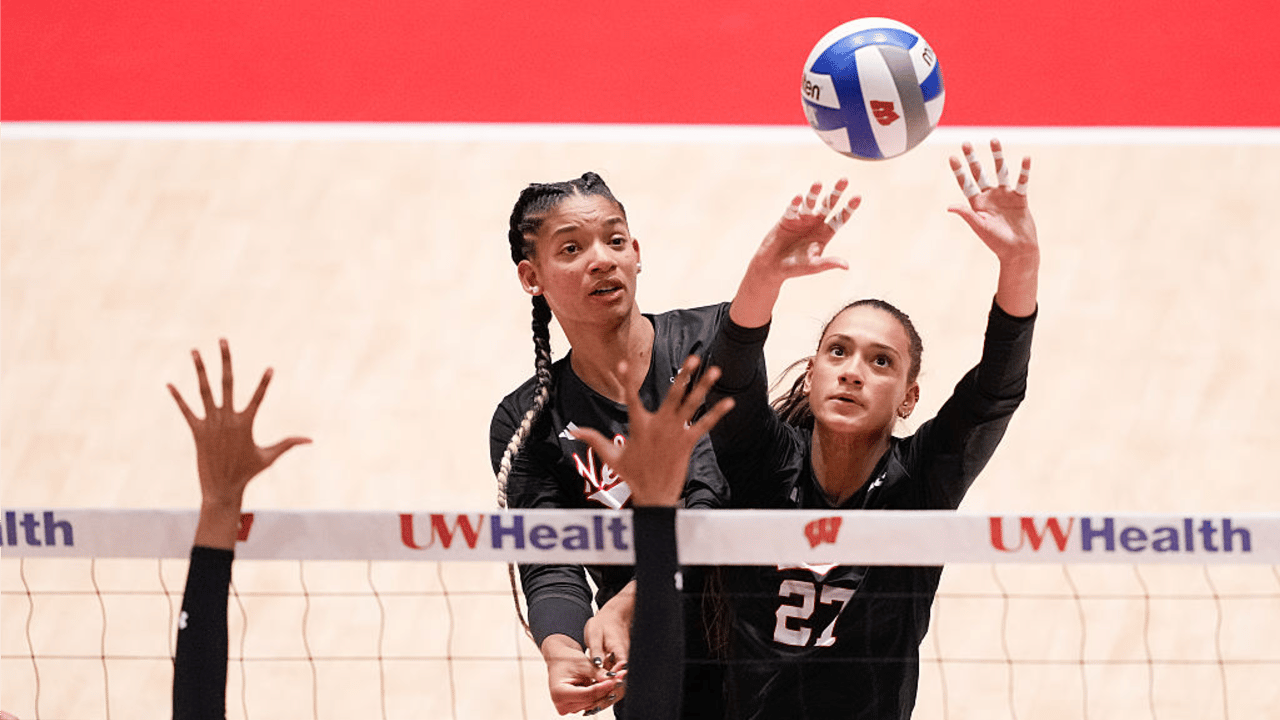 Harper Murray #27 of the Nebraska Cornhuskers sets the ball as Taylor Landfair, left, looks on against the Wisconsin Badgers during the second set at Wisconsin Field House on October 31, 2025 in Madison, Wisconsin.