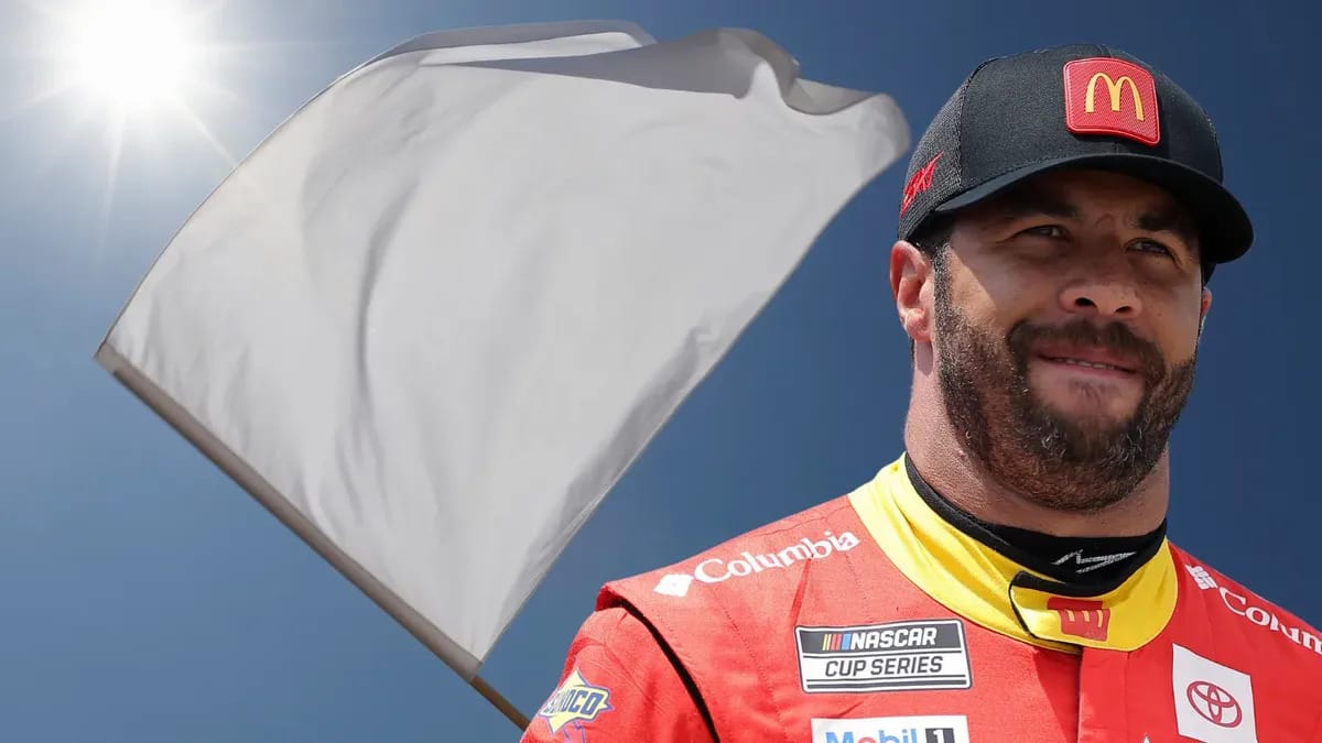 A Black man is shown next to a white flag.
