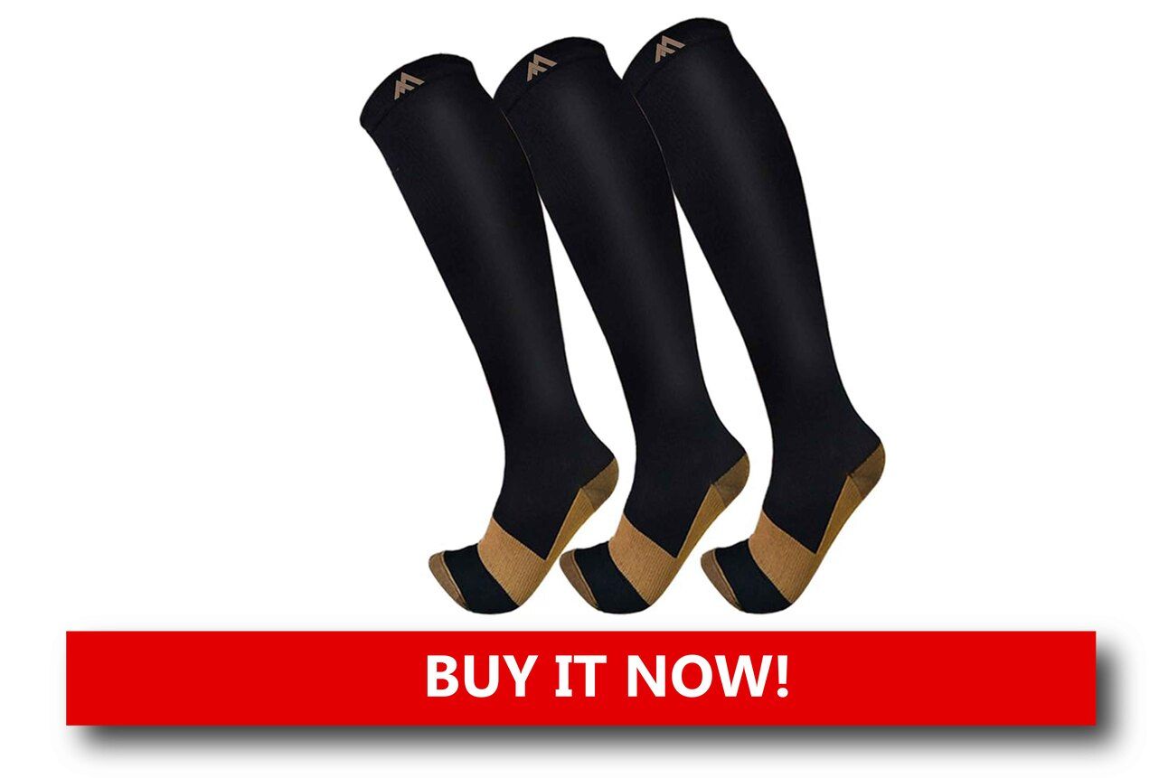 Compression Socks That Save Your Legs A pair of compression socks being worn by a passenger stretching their legs mid-flight, with airplane seats and windows in the background.