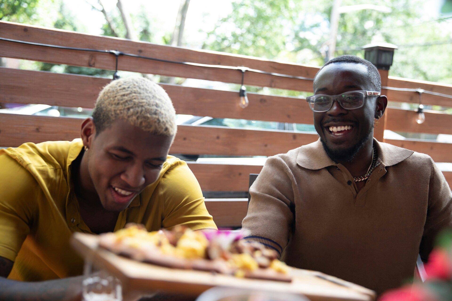 Men laughing together over a meal