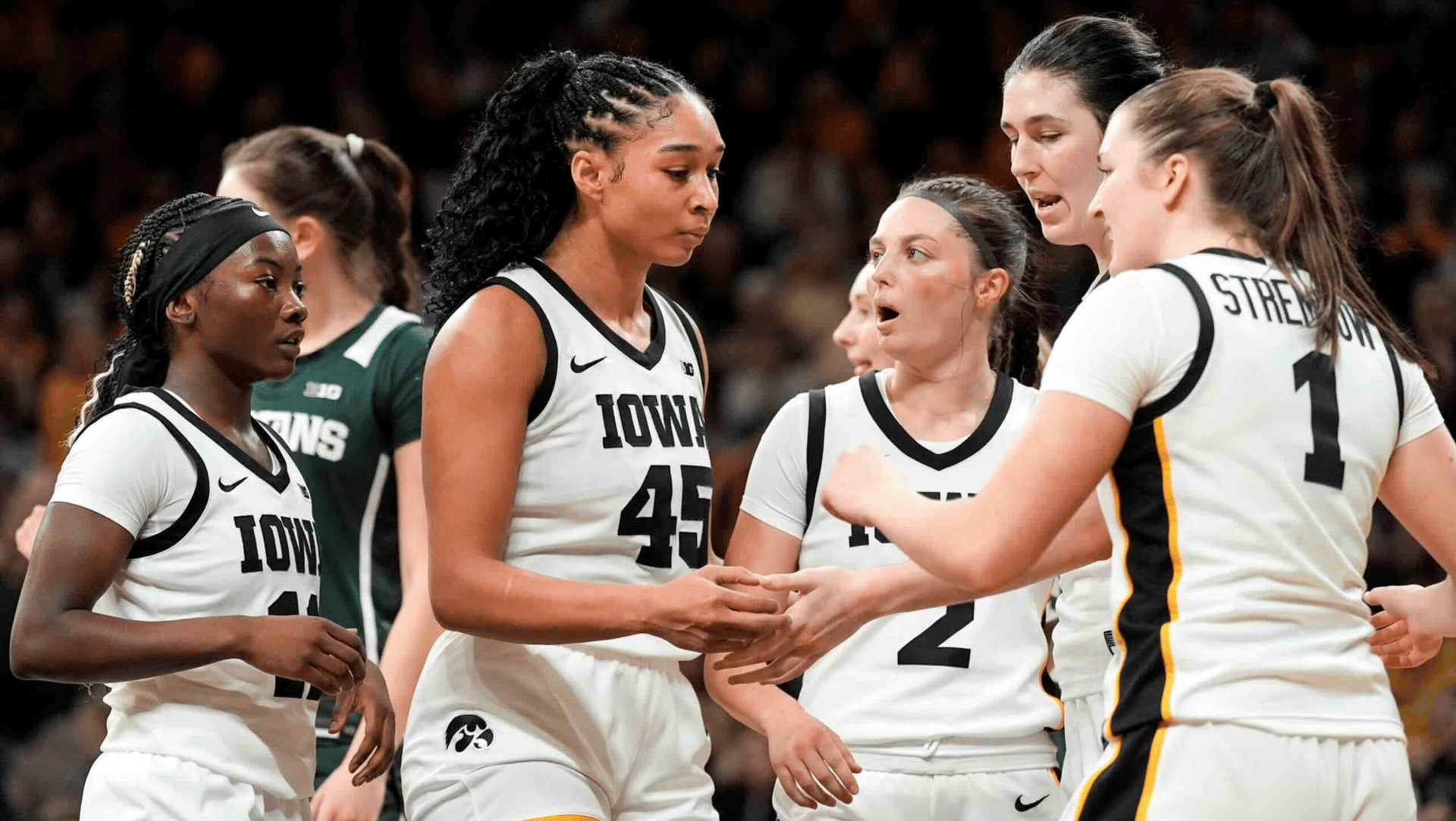Iowa's Chit-Chat Wright (11), Hannah Stuelke (45), Taylor McCabe (2), Ava Heiden (5) and Taylor Stremlow (1) huddle during a game against the Michigan State Spartans Jan. 18, 2026 at Carver-Hawkeye Arena in Iowa City, Iowa.