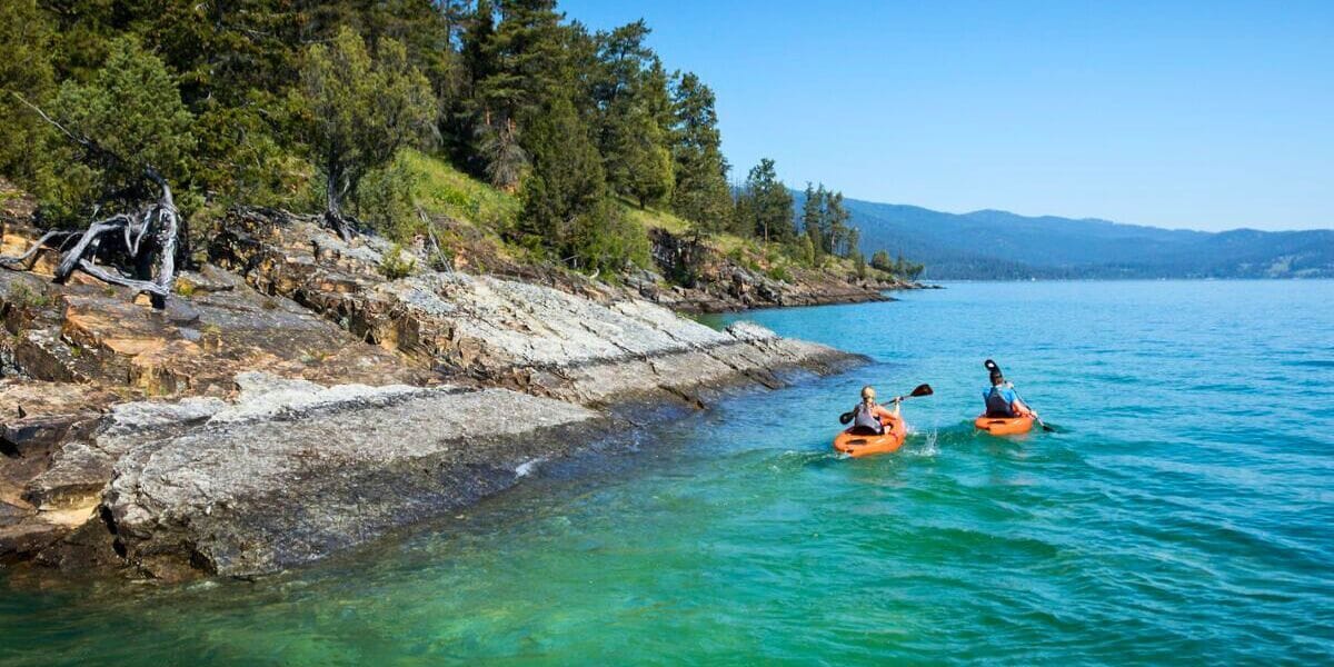 two people kayaking near an island