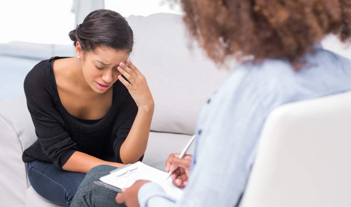 woman speaking with a counselor about her shopping addiction