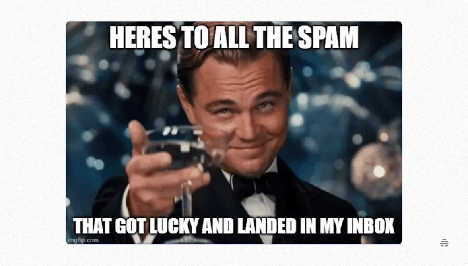 Meme of a well-dressed person raising a champagne glass with text joking about spam emails that still land in an inbox, highlighting email deliverability challenges familiar to newsletter creators and email marketers.