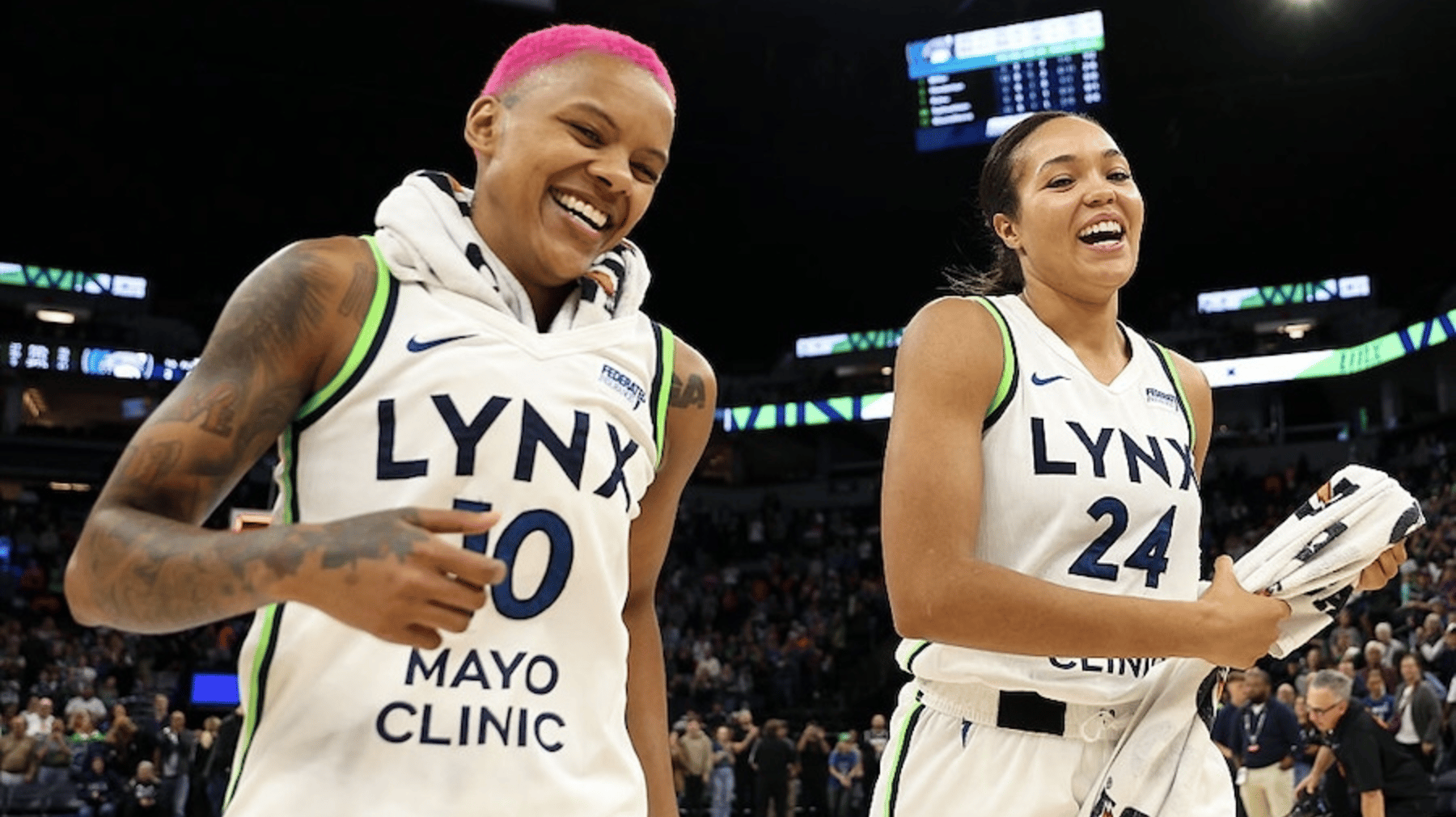 Courtney Williams #10 of the Minnesota Lynx and Napheesa Collier #24 celebrate their teams win
