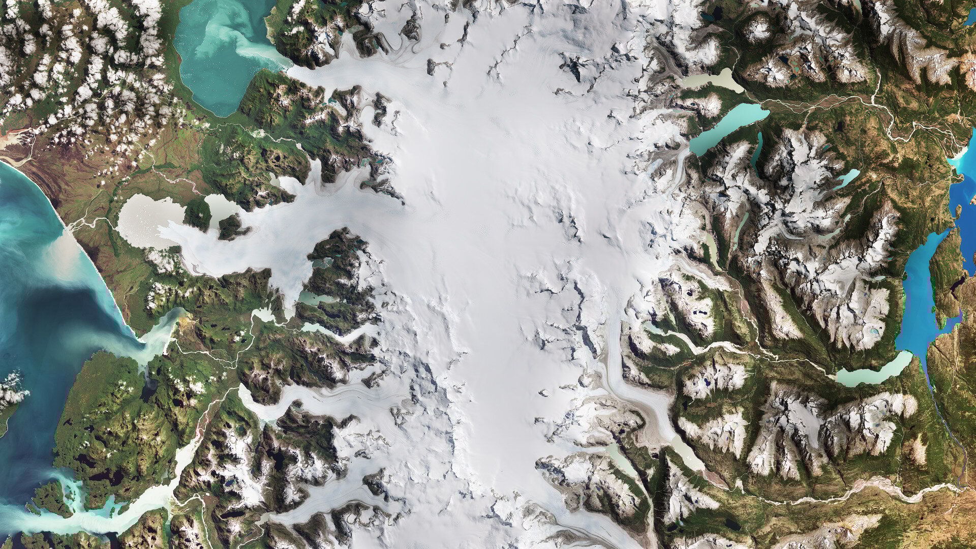 Satellite images from 1987 and 2024 reveal dramatic retreat of Chile’s San Rafael and San Quintín glaciers, the two largest outlets of the Northern Patagonian Ice Field. Once part of a vast ice sheet, the region now holds the second largest ice mass outside the poles. Over nearly four decades, both glaciers have receded significantly, San Rafael continues to calve into Laguna San Rafael, while San Quintín’s terminus has pulled back to form a new proglacial lake. In this 2024 image, the changing water color, from deep blue to milky aquamarine, reflects sediment-rich meltwater known as “glacier milk.” These shifts illustrate the accelerating impact of global warming on cryospheric systems. As glaciers melt, they contribute to sea-level rise, one of the most visible consequences of climate change.