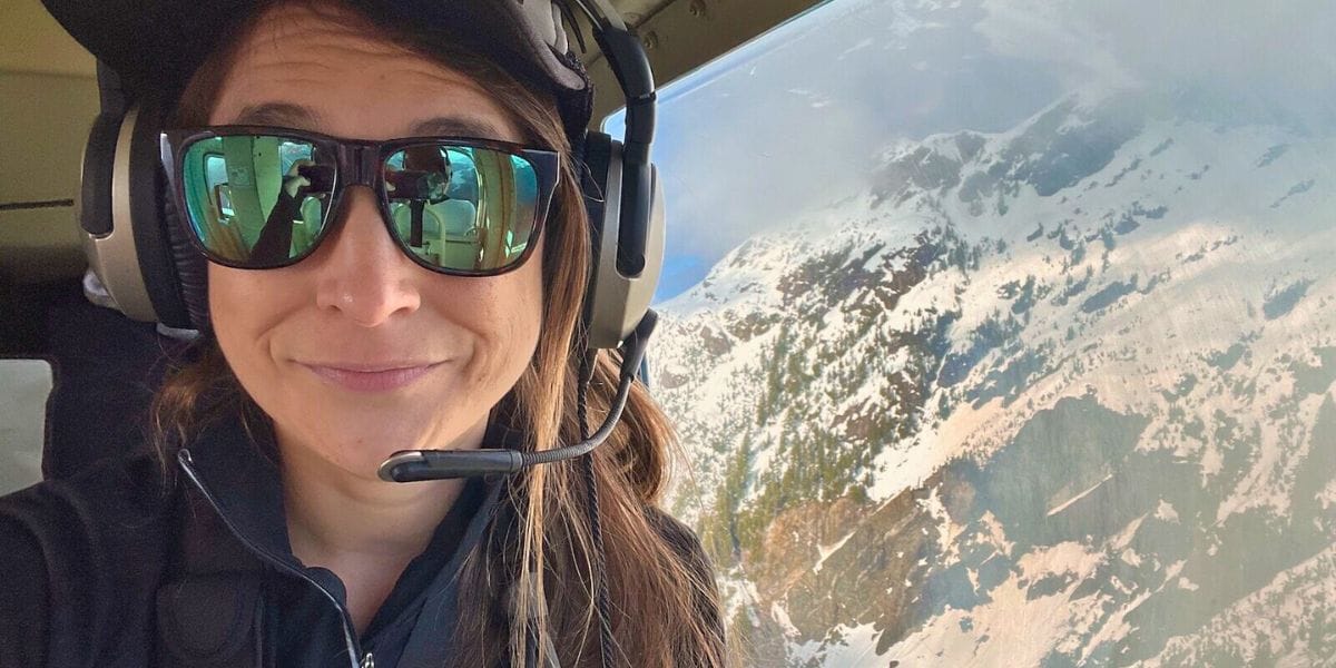 Suzie with cool glasses on in a helicopter