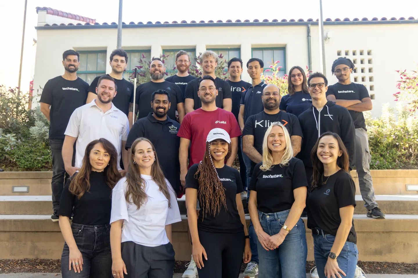 Group photo of all the employees and founders on stairs at the new Techstars cohort. 