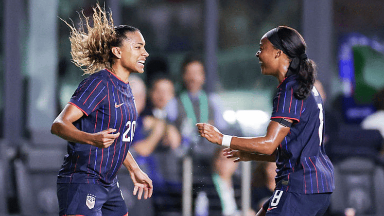 Catarina Macario #20 of the United States celebrates scoring with teammate Jaedyn Shaw #8 during the first half against Italy during an international friendly at Chase Stadium on December 01, 2025 in Fort Lauderdale, Florida.